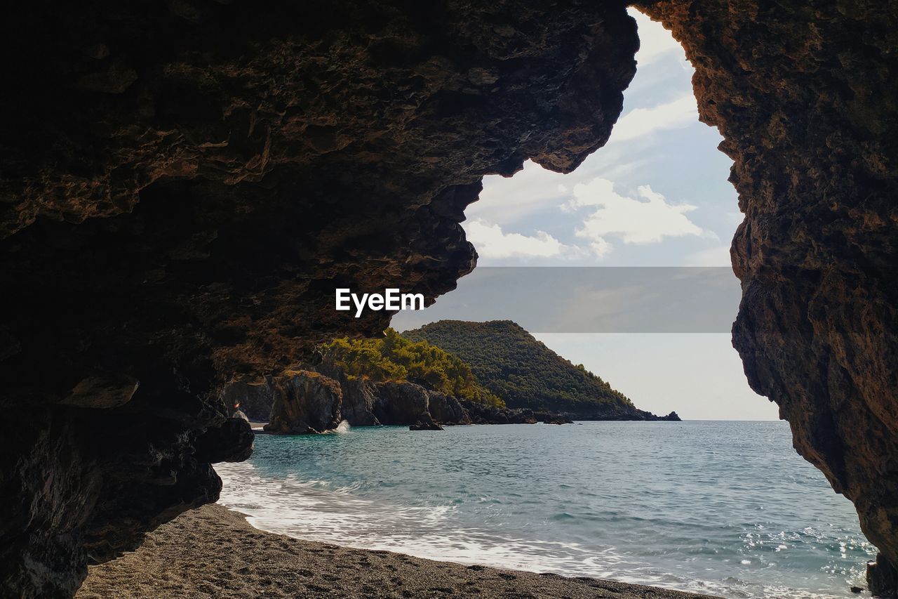 Scenic view of sea seen through cave