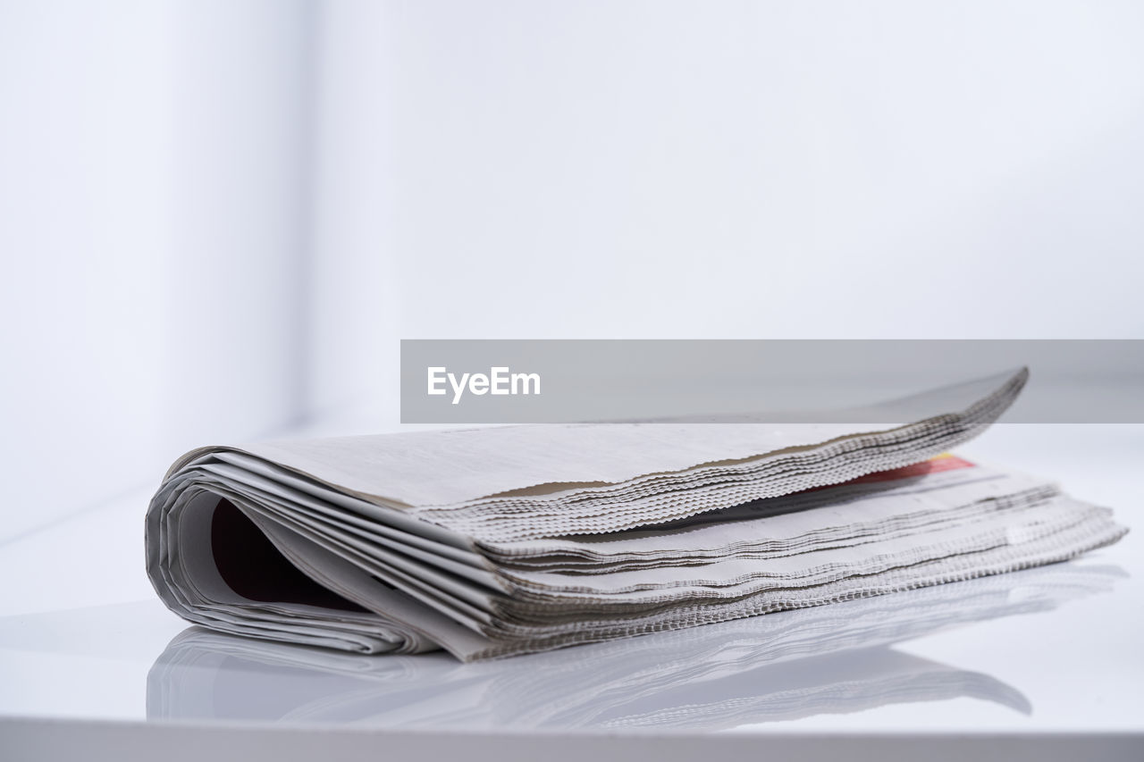 Close up of folded newspaper by window