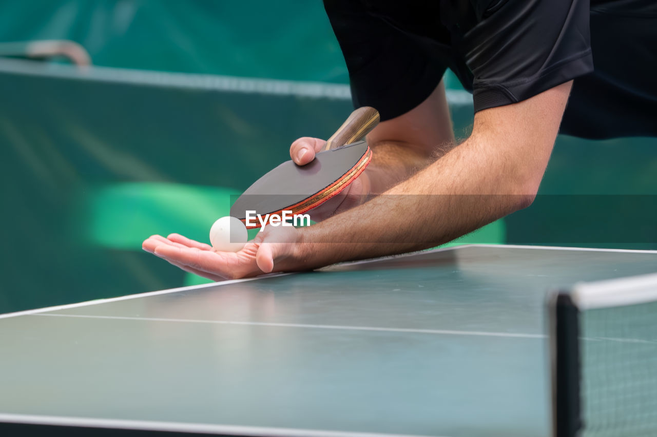 Close up of a table tennis player serving