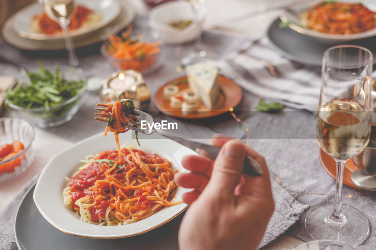 HIGH ANGLE VIEW OF PERSON HAVING FOOD ON TABLE