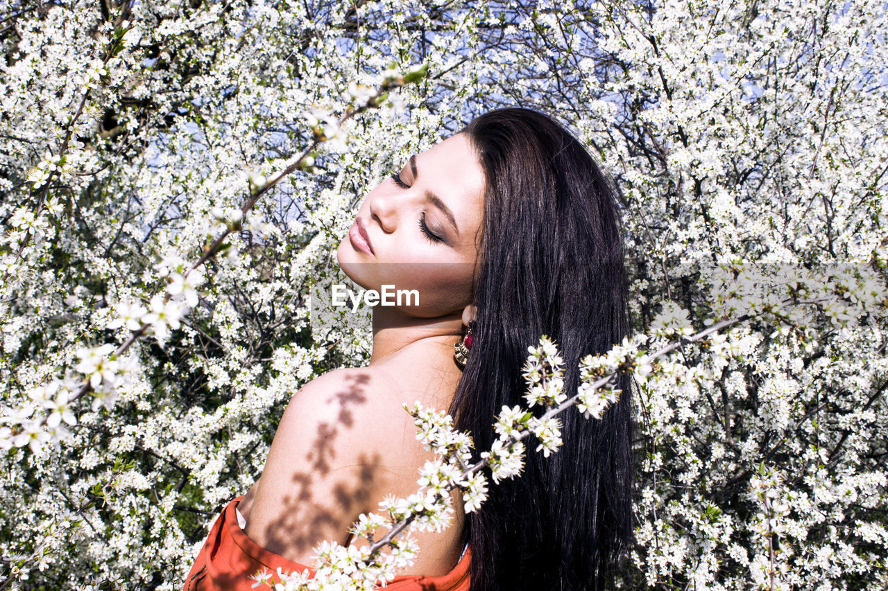 Young woman amidst flowering plants