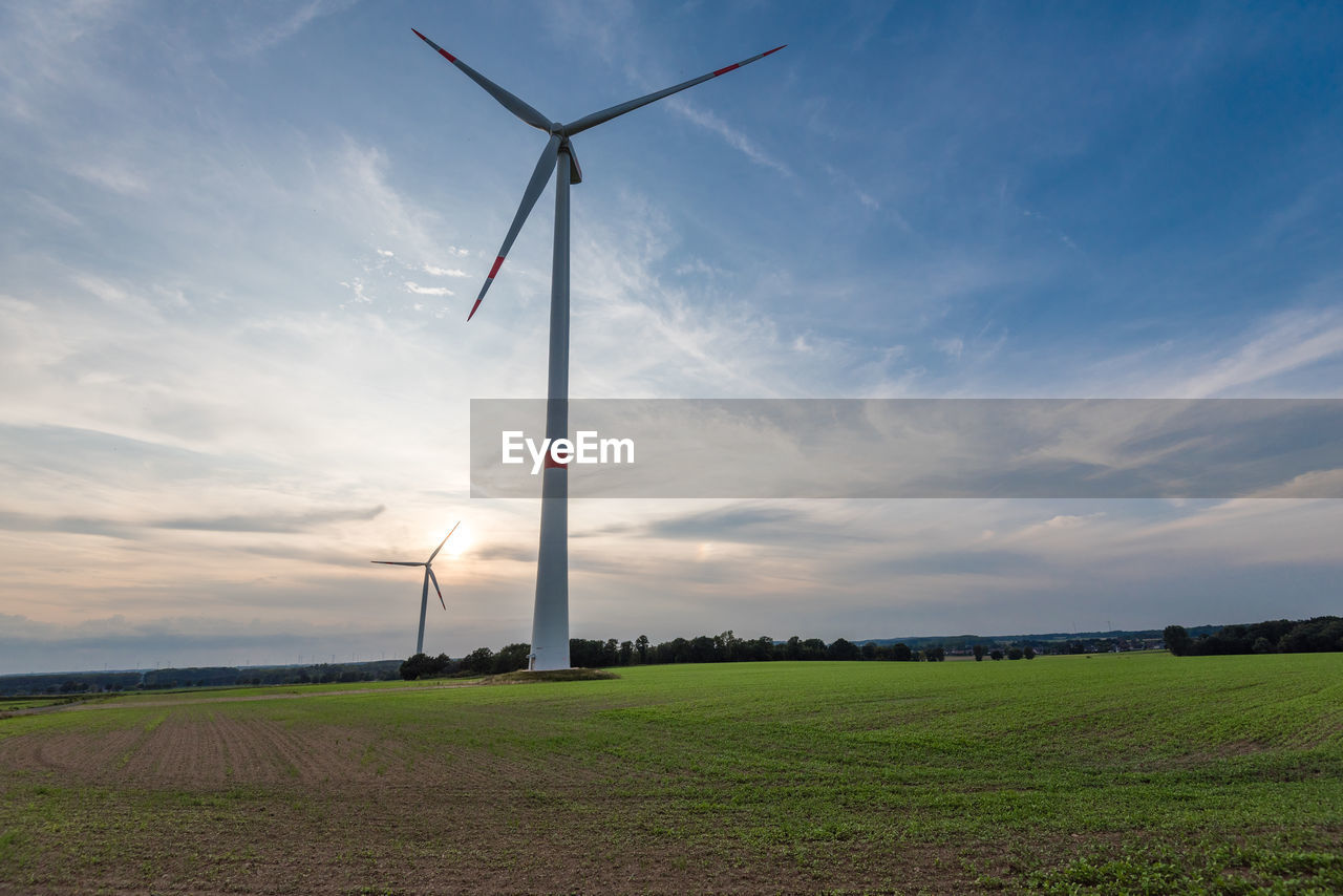 Windmill on field against sky