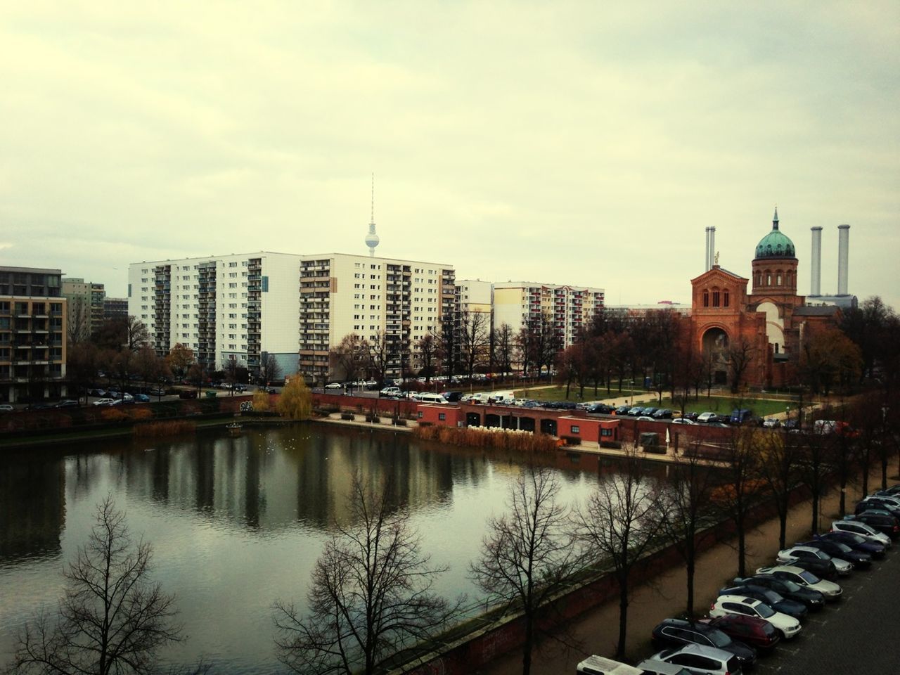 High angle view of artificial pond and buildings against sky