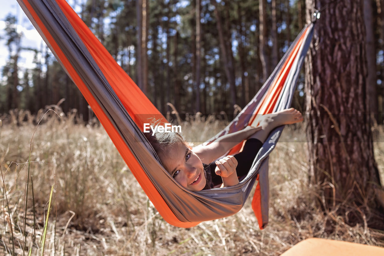 Portrait of girl lying on hammock