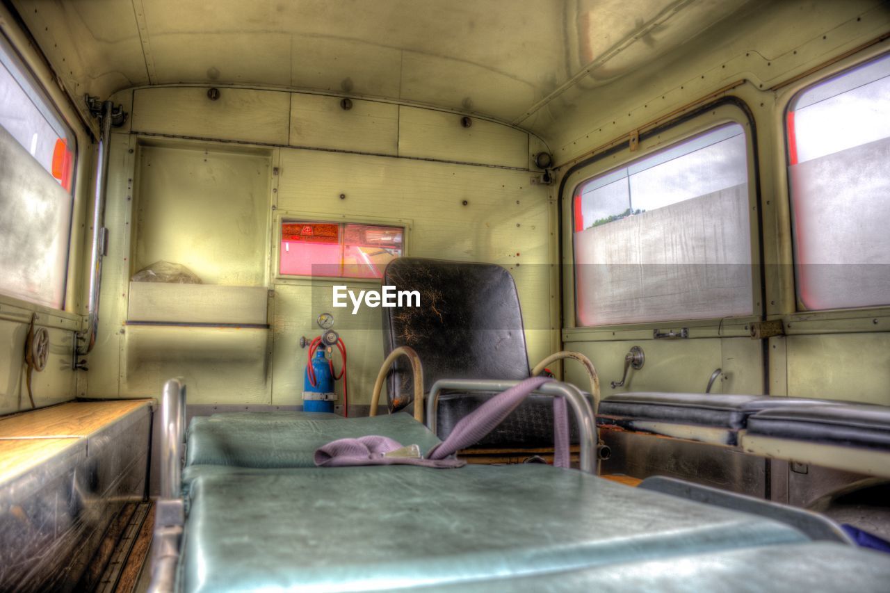 REAR VIEW OF MAN SITTING IN BUS