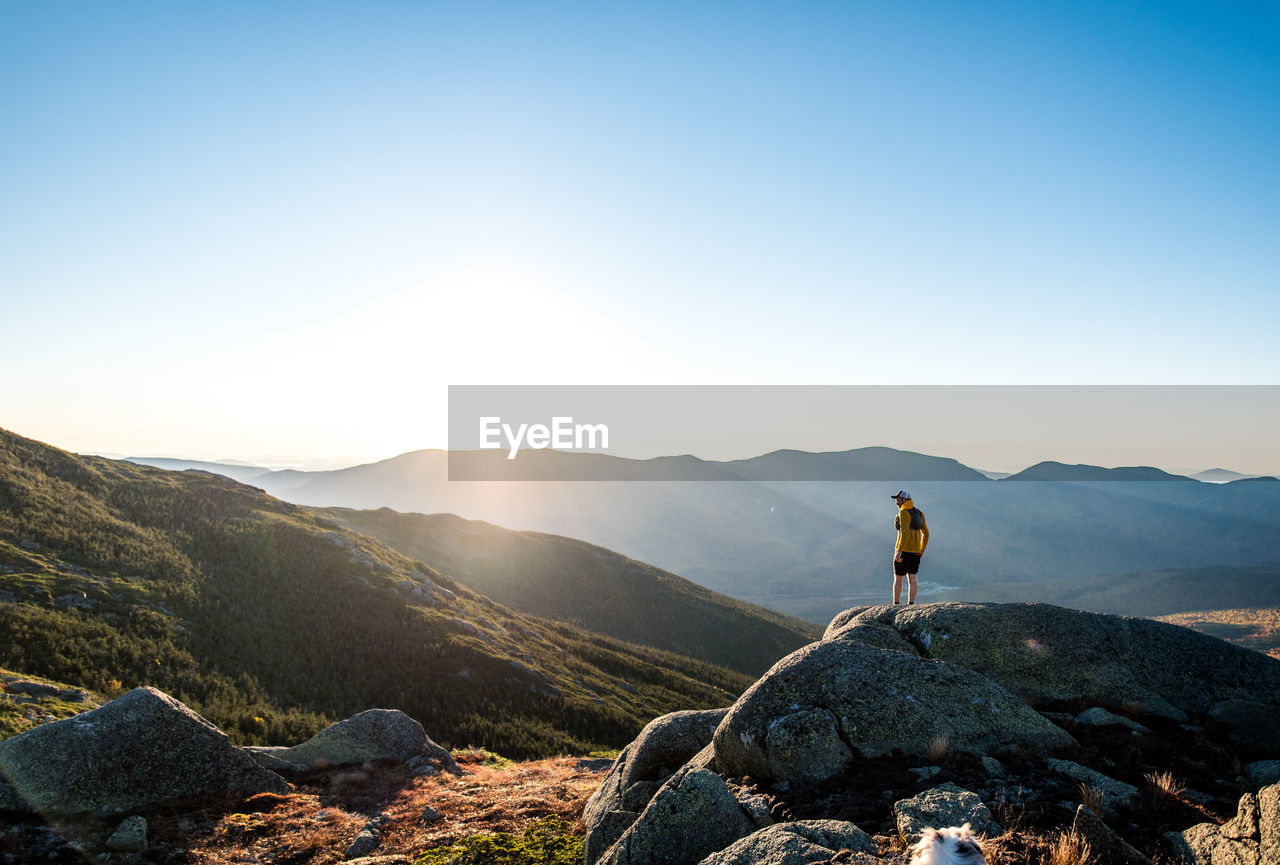 Man looking over the white mountains while on a trail run at sunrise