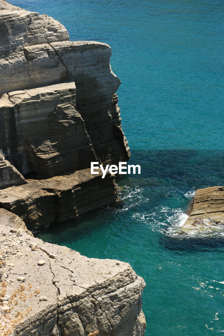 High angle view of rock formation in sea