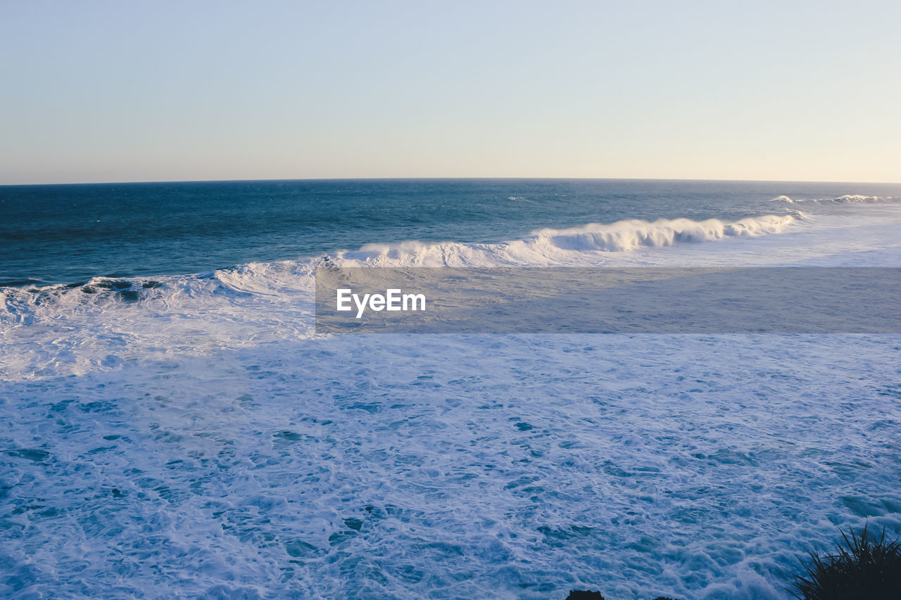 Scenic view of sea against clear sky during sunset