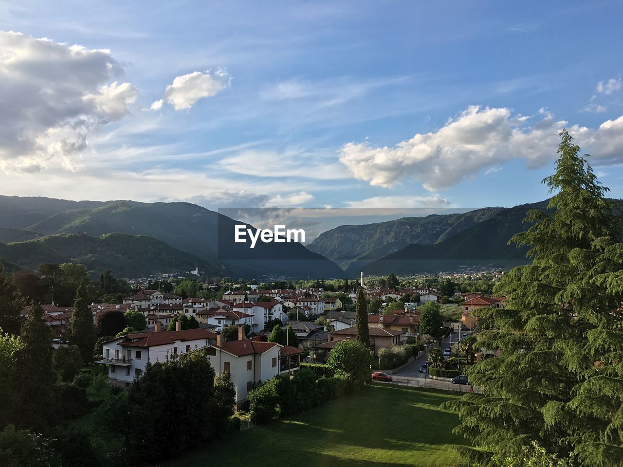 Townscape by mountains against sky