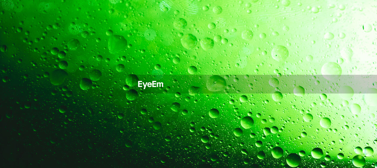 FULL FRAME SHOT OF RAINDROPS ON GLASS