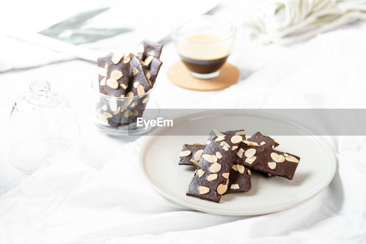 HIGH ANGLE VIEW OF CHOCOLATE CAKE ON GLASS TABLE