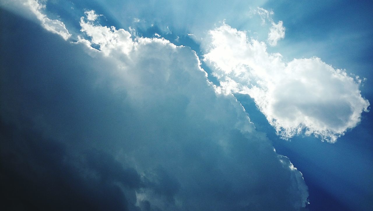 LOW ANGLE VIEW OF WAVES BREAKING AGAINST SKY