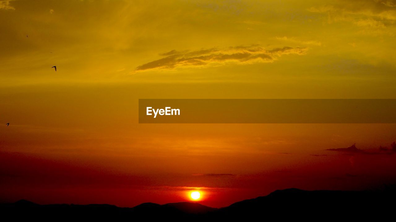 Silhouetted mountains during sunset