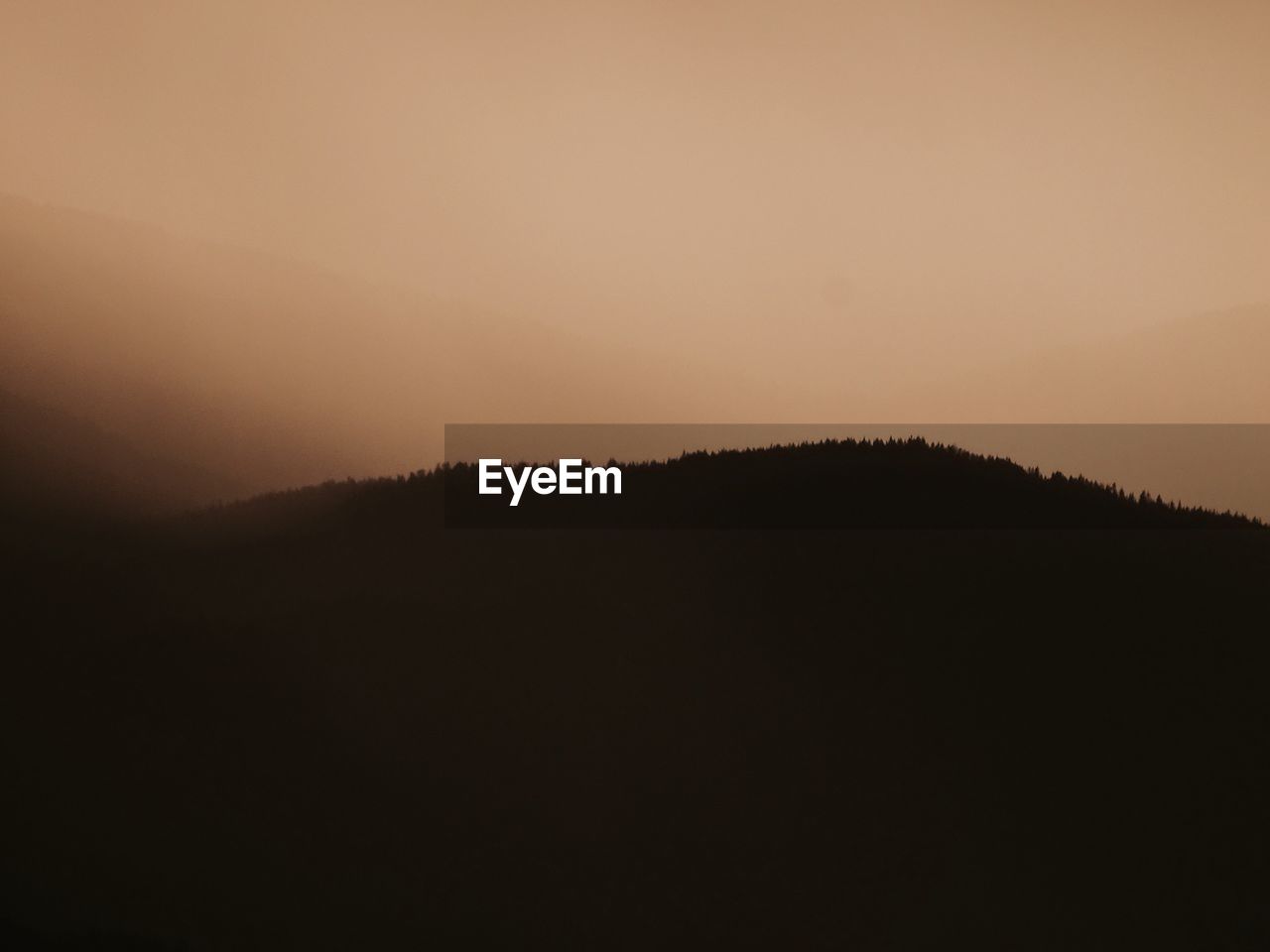 SILHOUETTE OF MOUNTAINS AGAINST SKY