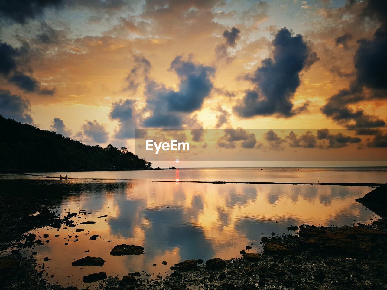 Scenic view of lake against orange sky