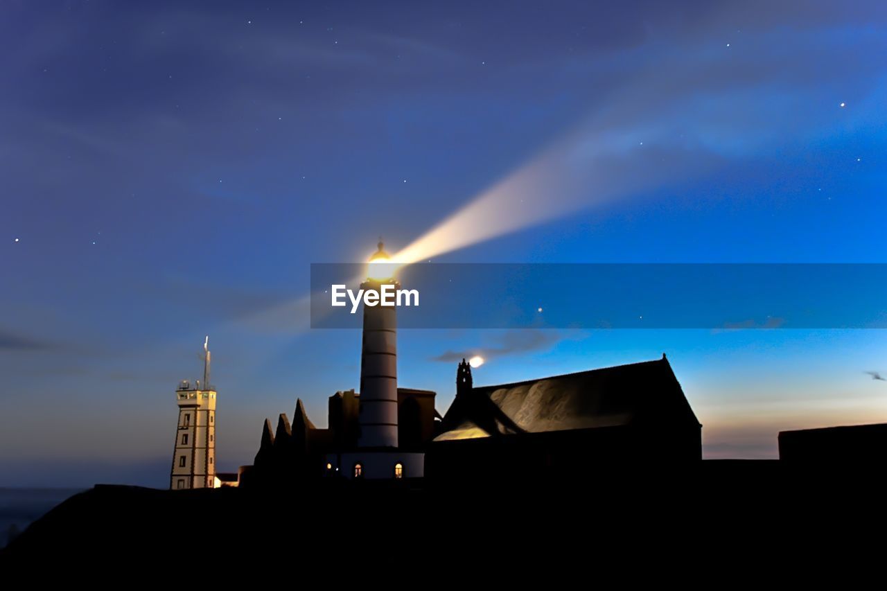 Low angle view of illuminated building against sky at night