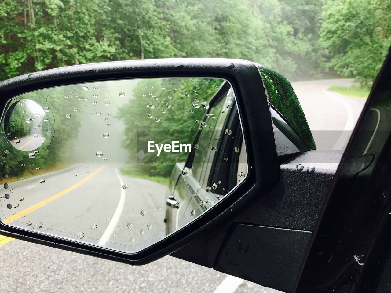 CLOSE-UP OF CAR ON SIDE-VIEW MIRROR