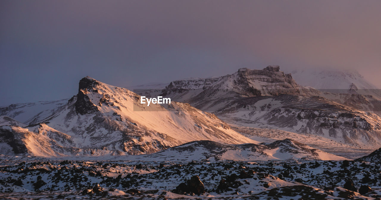 Scenic view of snowcapped mountains against clear sky