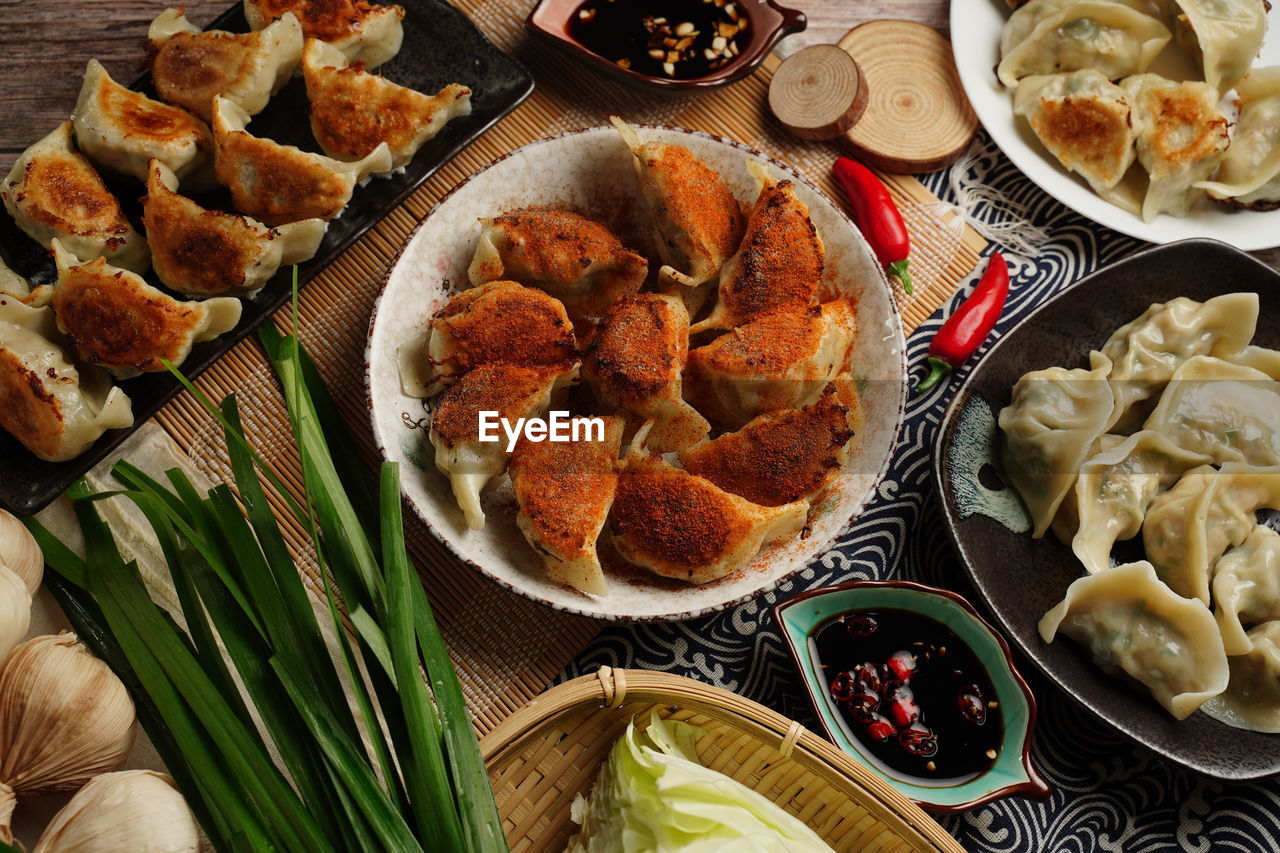 Fried dumplings are dumplings cooked in a pan