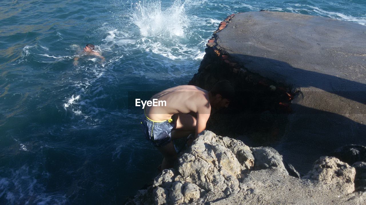 Shirtless man in sea