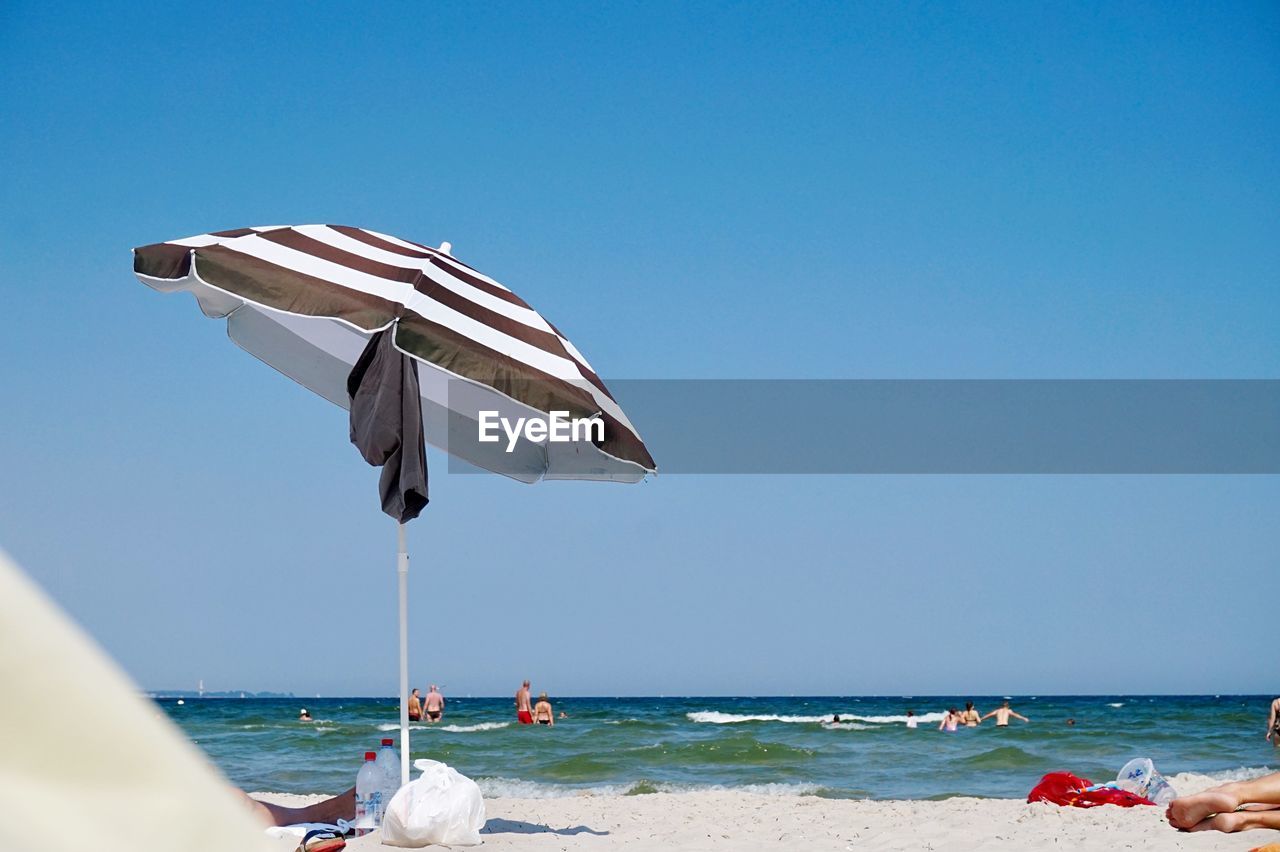 SCENIC VIEW OF BEACH AGAINST CLEAR BLUE SKY