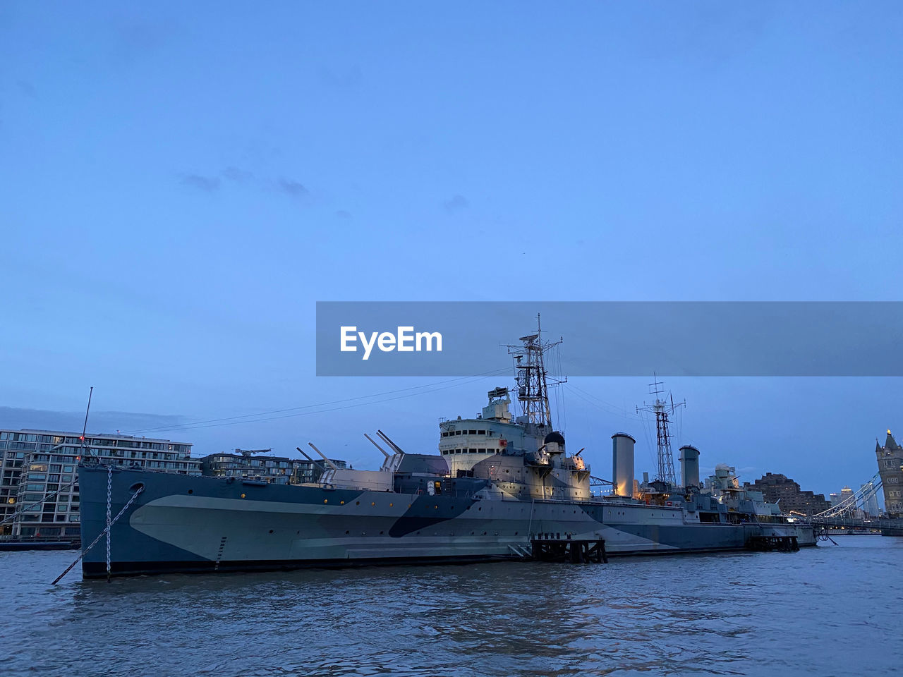 Hms belfast on river thames in london at dusk