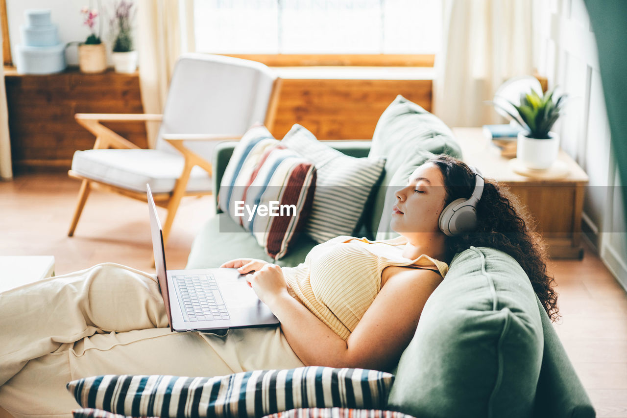 midsection of woman using laptop on bed at clinic