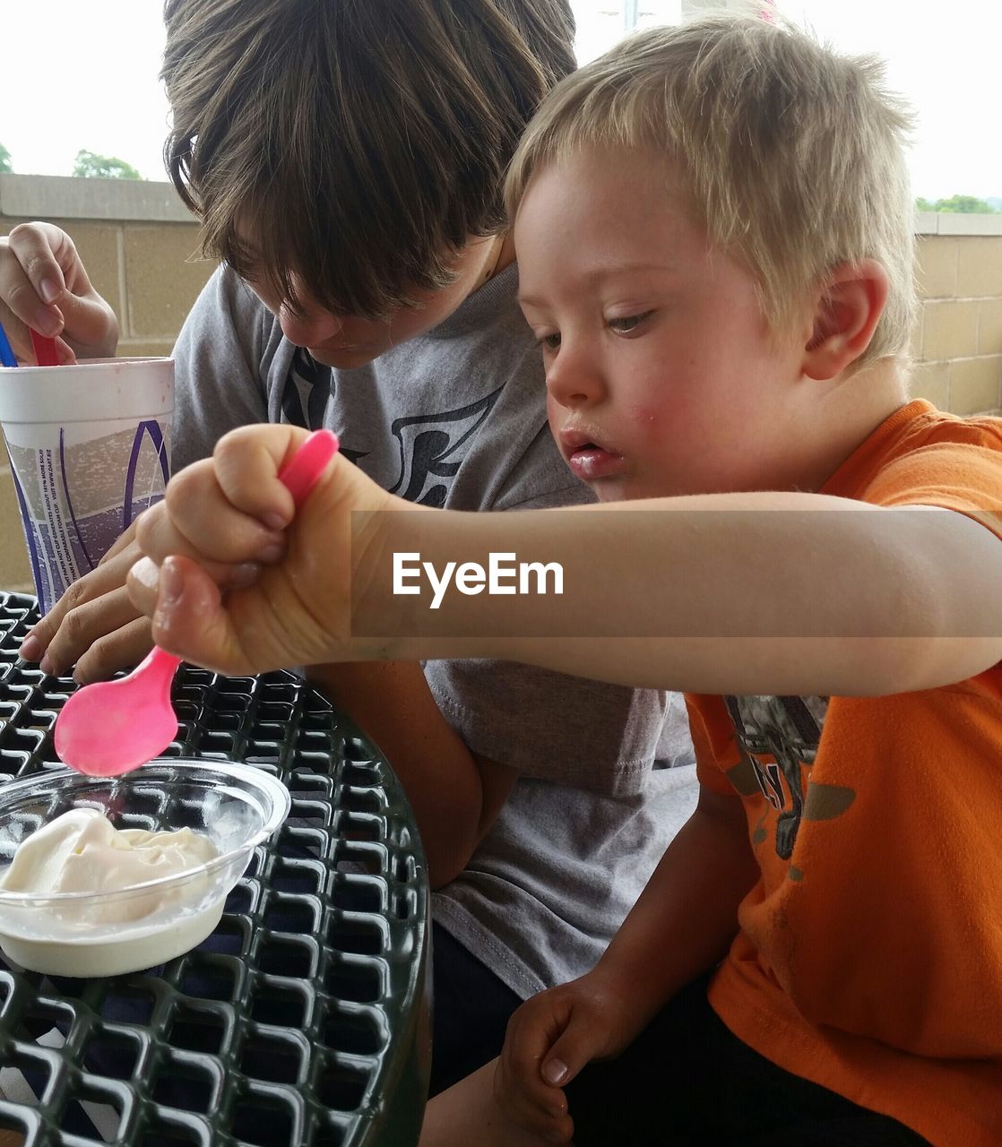 CLOSE-UP OF BOY EATING FOOD IN PLATE