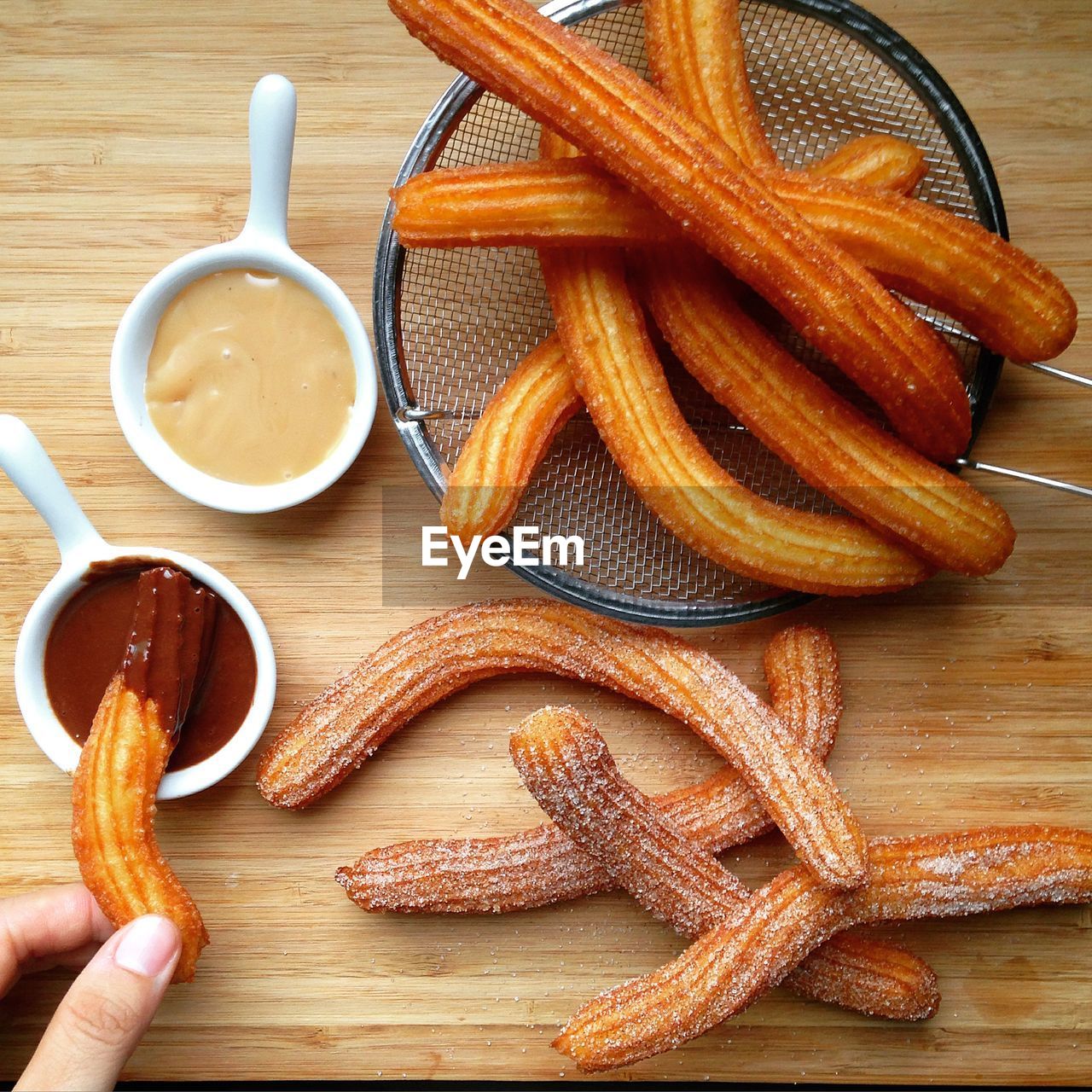 Cropped image of person having churro