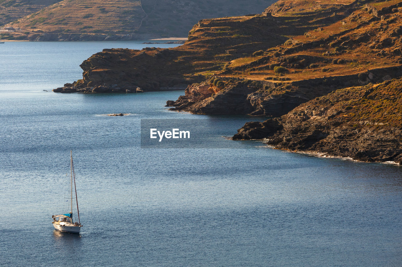 Sail boat at the coast of kythnos island in greece.
