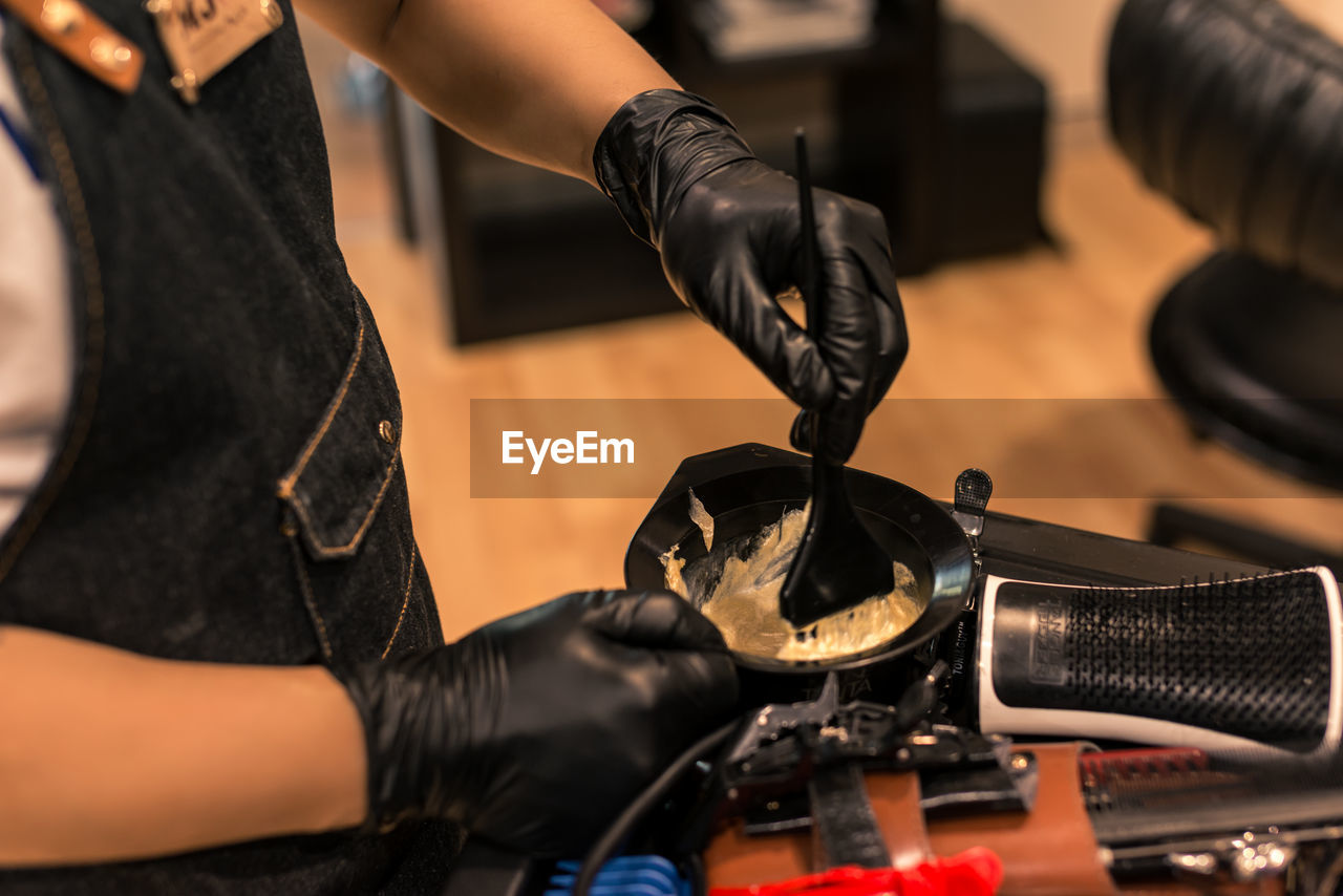 Midsection of barber working in salon