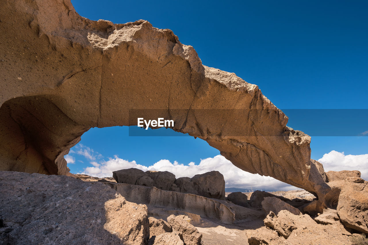 ROCK FORMATIONS AGAINST BLUE SKY