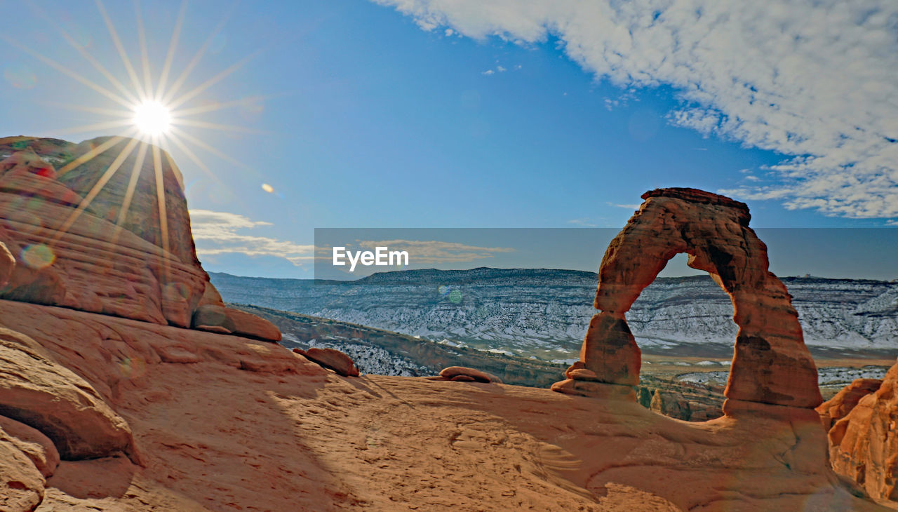 scenic view of rock formations against sky