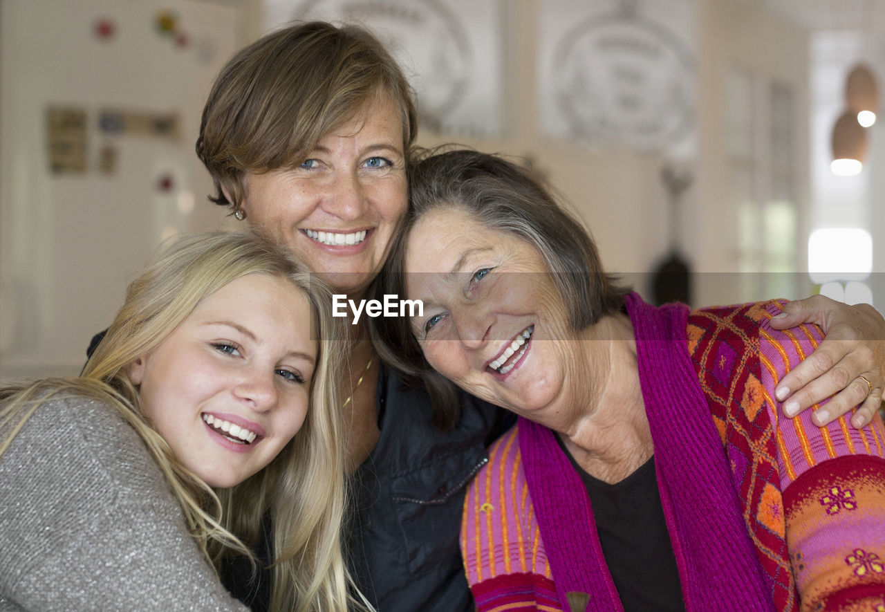 Portrait of happy three generation females at home