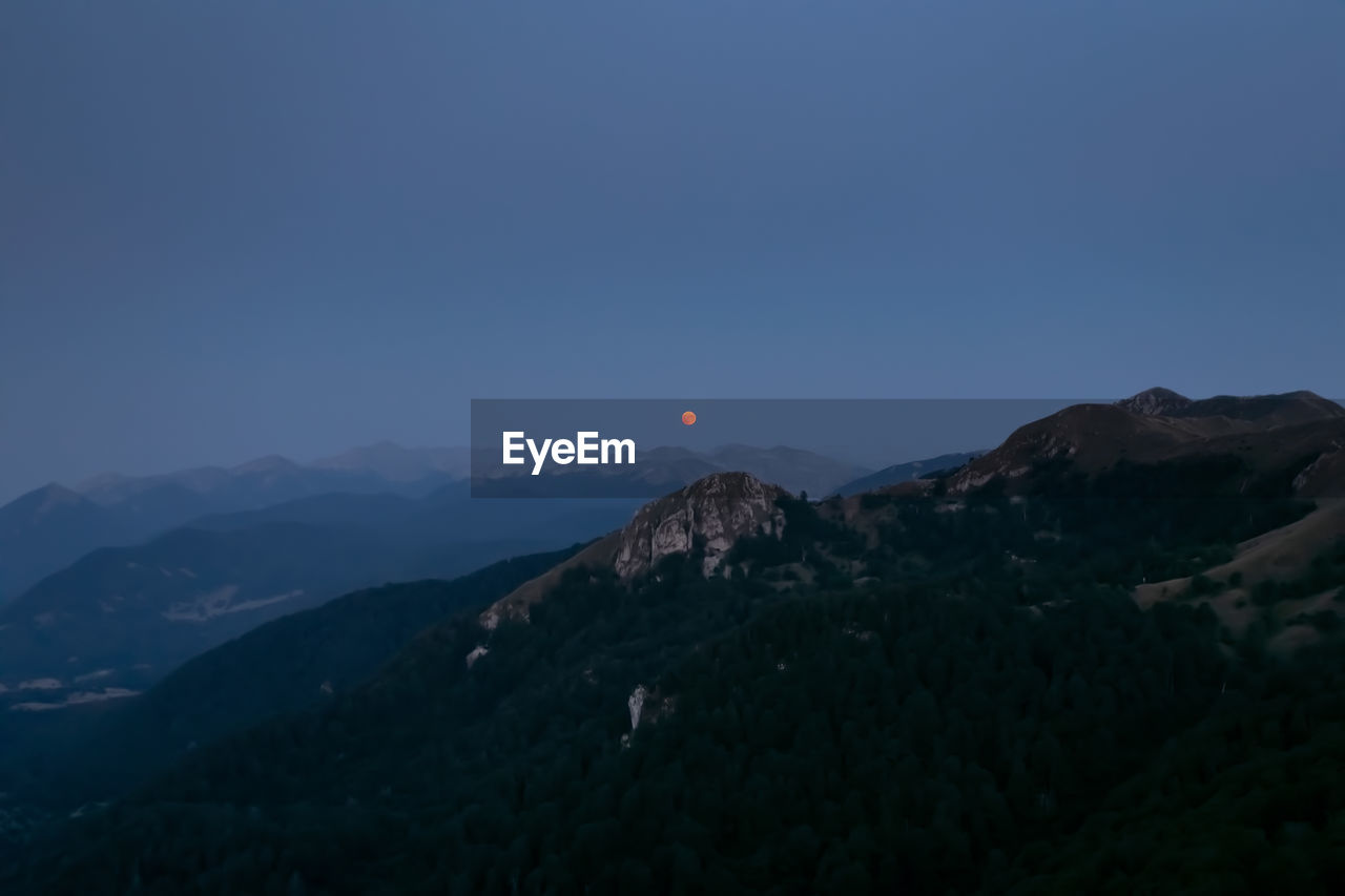 SCENIC VIEW OF MOUNTAIN AGAINST BLUE SKY