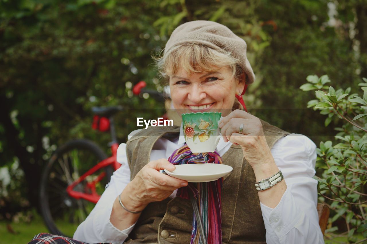 Portrait of smiling senior woman holding tea cup