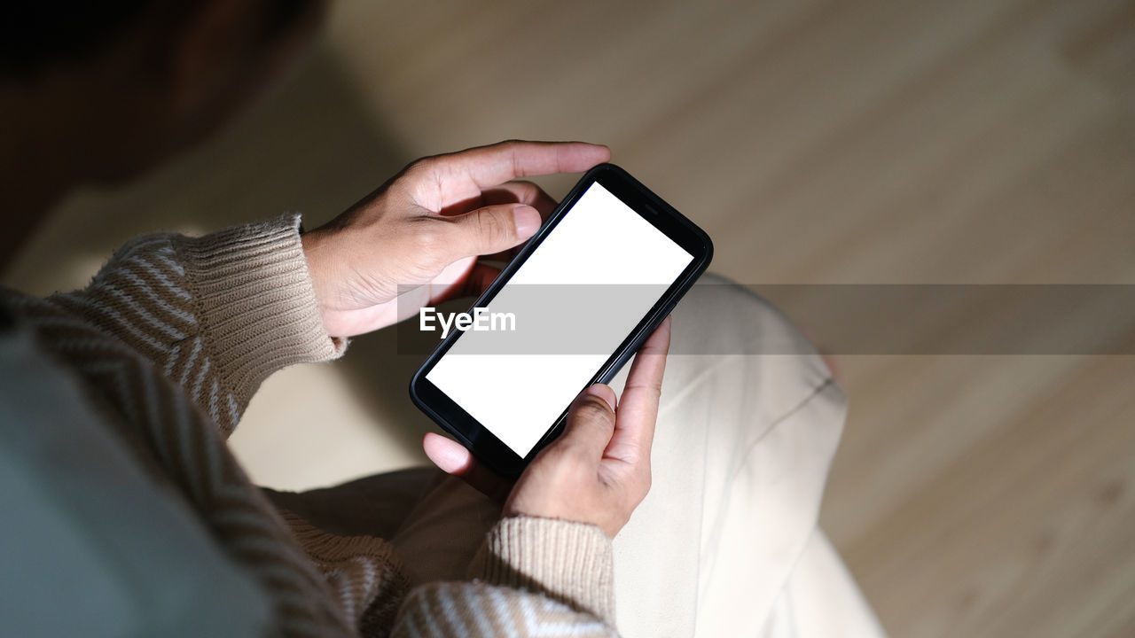 midsection of woman using smart phone