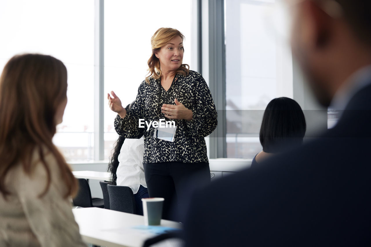 Businesswoman presenting before colleagues during meeting