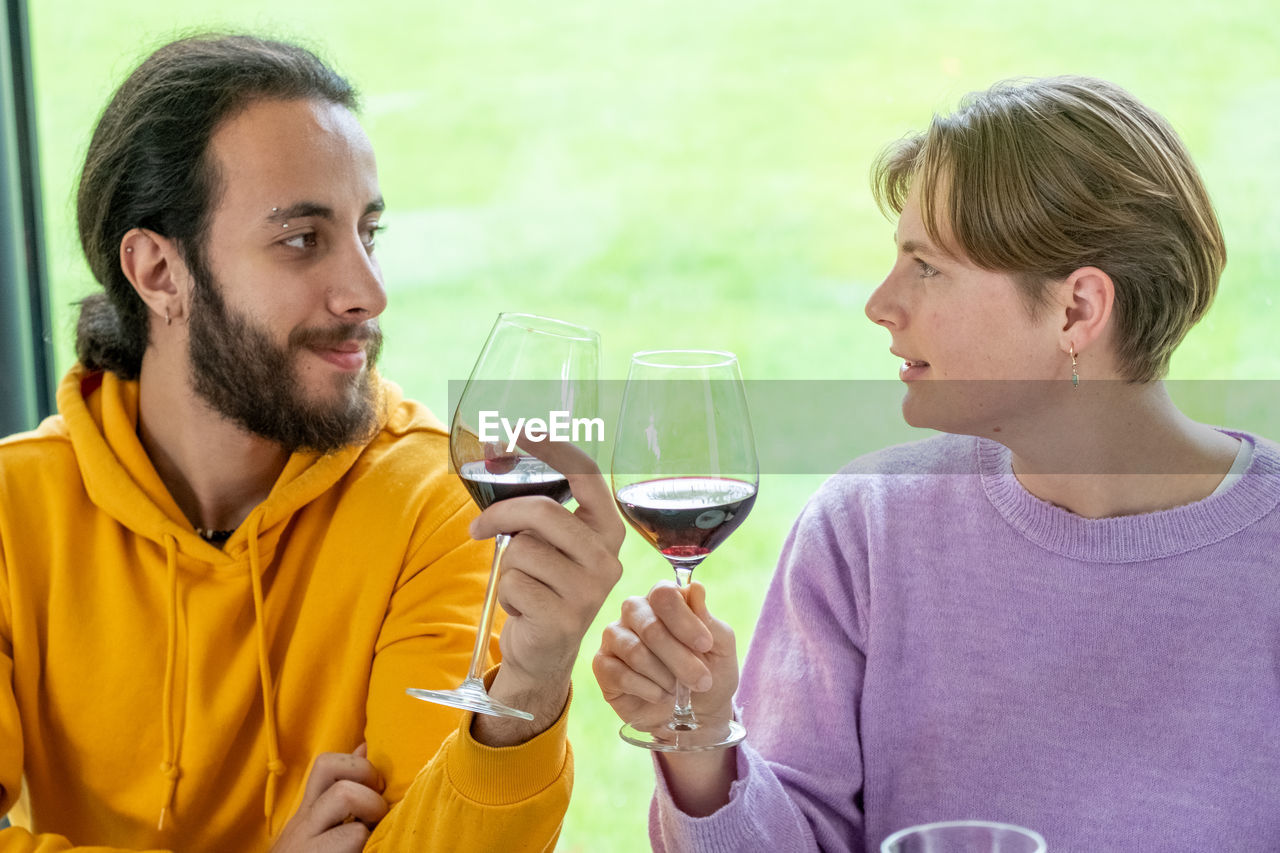 portrait of young man holding wineglass