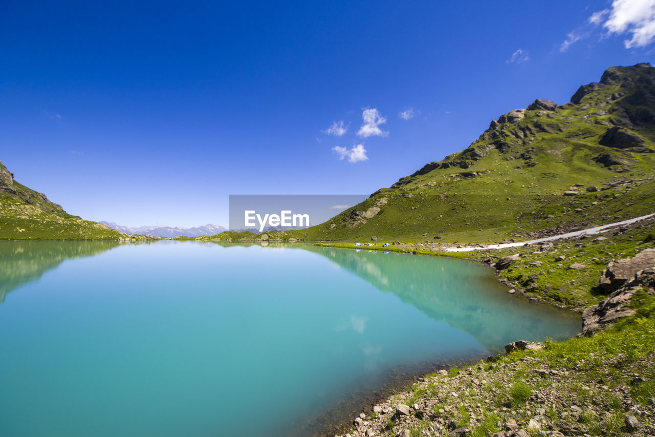 Alpine mountain lake landscape and view, blue beautiful and amazing lake wide angle lens landscape