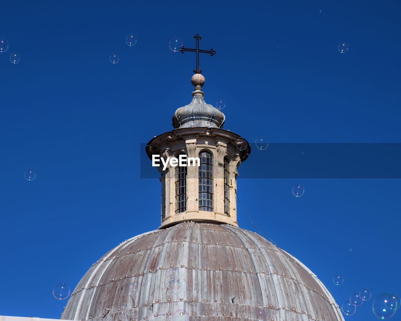 Low angle view of dome lantern against blue sky