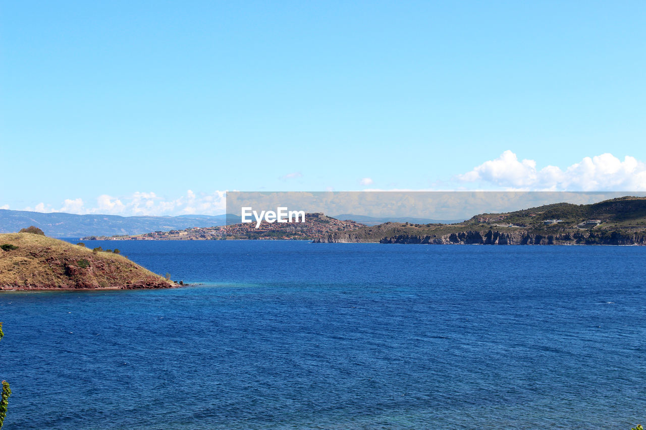 Scenic view of mountains against blue sky