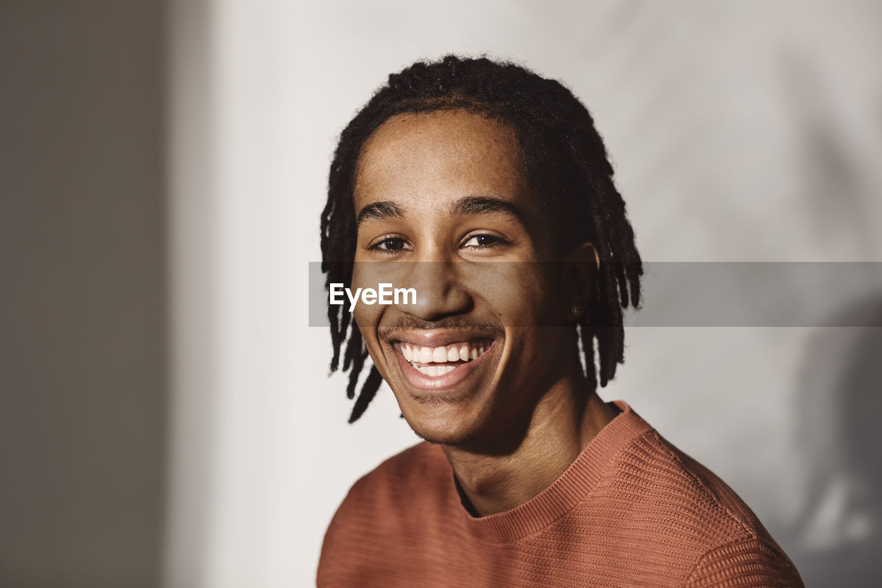 Portrait of happy young man over white background in studio