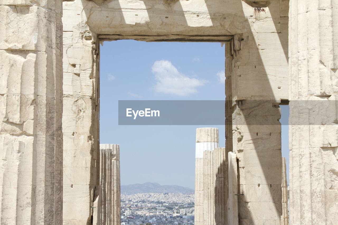Residential district seen through doorway in historical building against sky