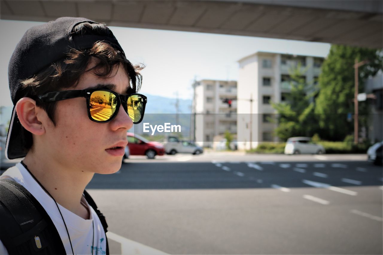 Boy wearing sunglasses in city