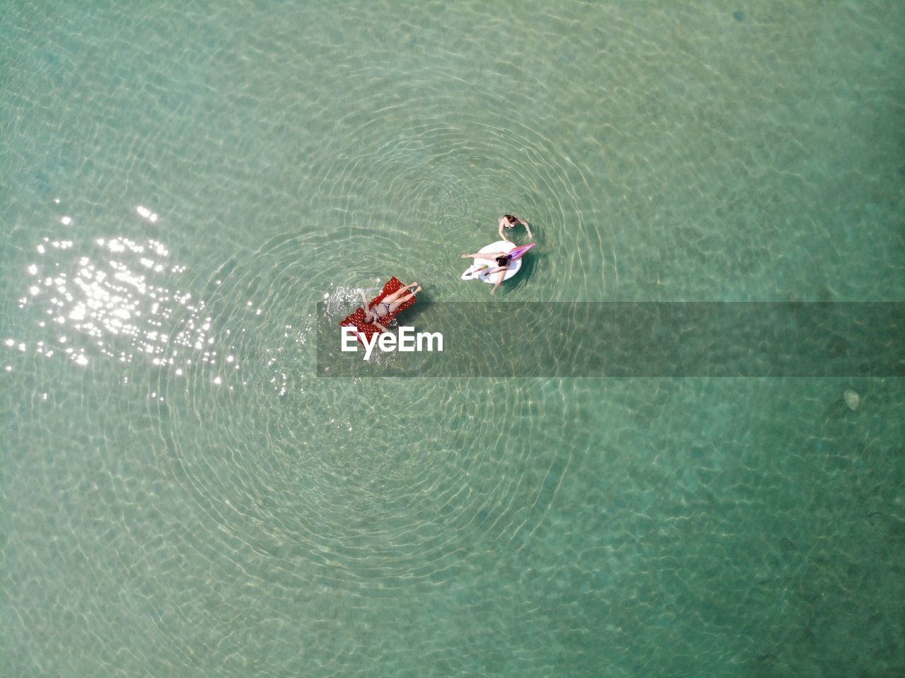 HIGH ANGLE VIEW OF PEOPLE IN LAKE