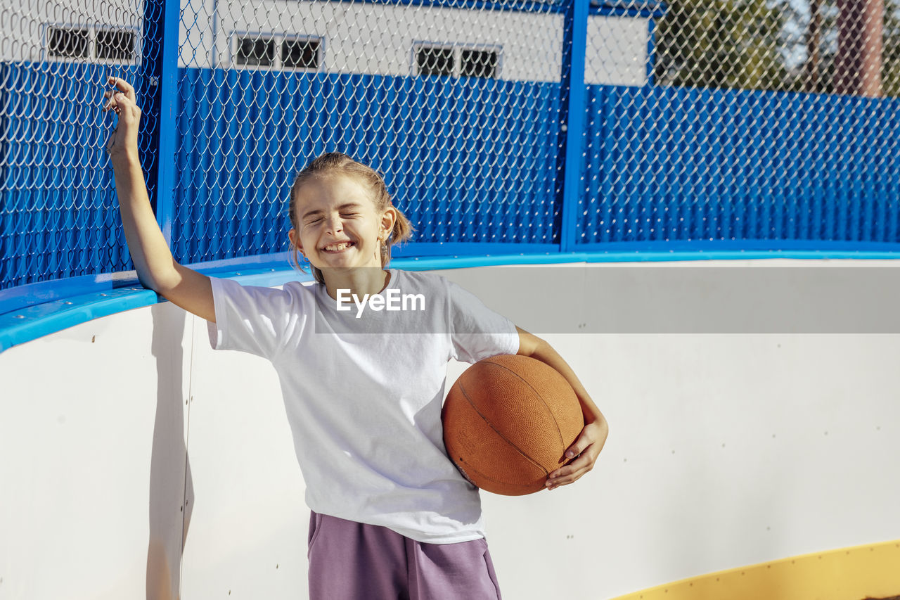 Golden hour glory, a girl's basketball passion shines bright in the sunset on the basketball court
