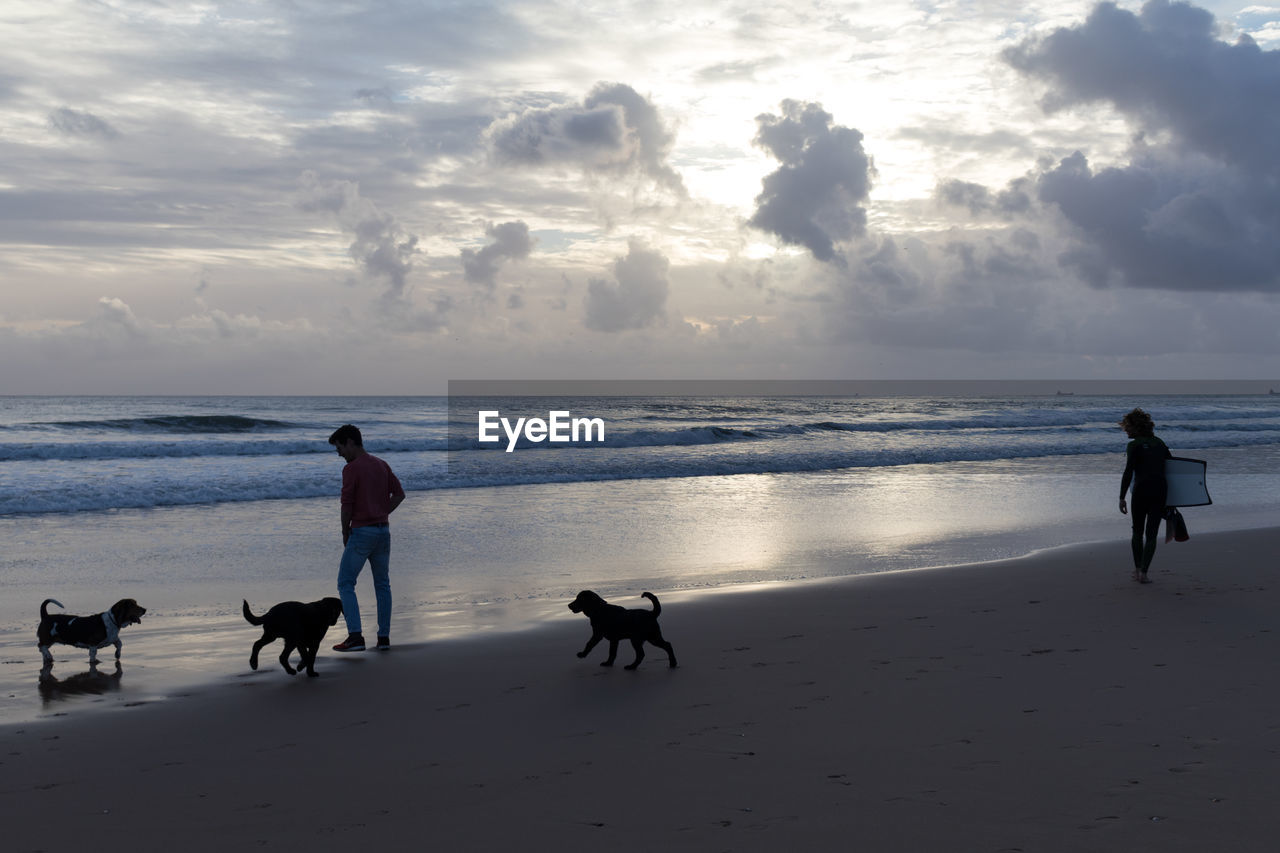 PEOPLE AT BEACH DURING SUNSET