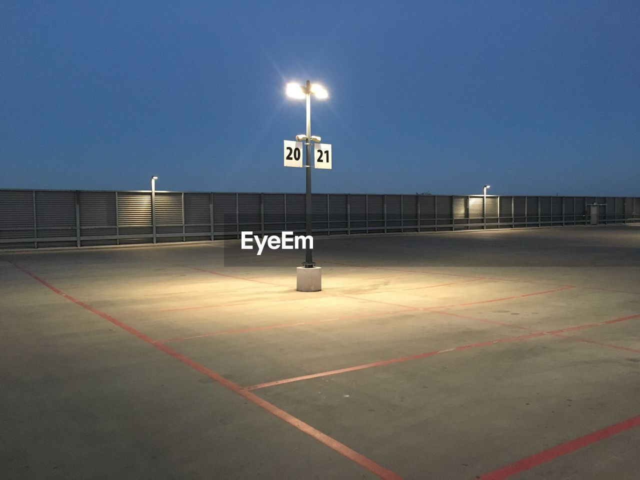 Low angle view of illuminated and empty parking lot