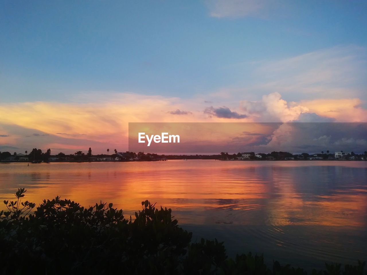 Scenic view of lake against sky during sunset